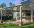 Covered patio with ceiling fans and a spacious backyard area
